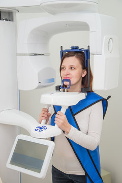 Patient in dentist clinic making 3d x ray using radiography equipment