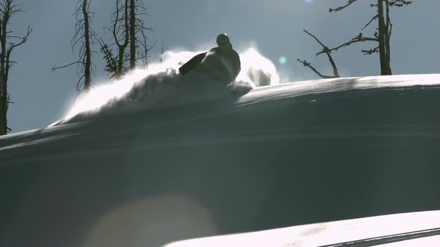 Snowmobile turning in deep powder in super slow motion