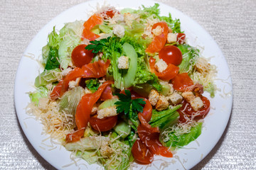 Caesar salad with chicken, cherry tomatoes, lettuce