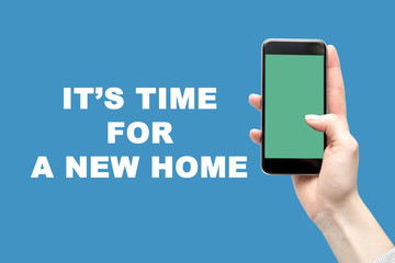 Smartphone in the woman's hand and the inscription is the time for a new home.