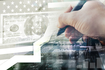 Hand writes with a digital pen. Internet banking, charts and quotes, a modern form of running a business. Double exposure.