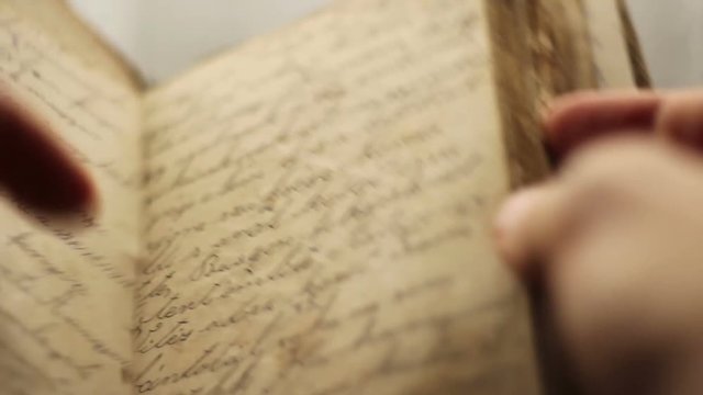 Close up of hands turning pages.