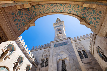 Washington DC Islamic Center mosque. View from interior courtyard looking up at minaret against blue sky - 156017490