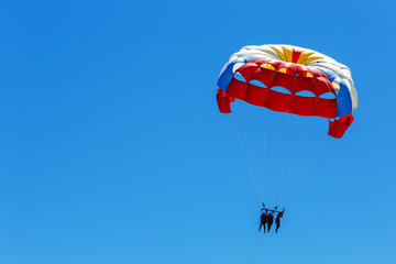 Parasailing, skydiving high in the blue sky