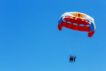 Wall murals Air sports Parasailing, skydiving high in the blue sky