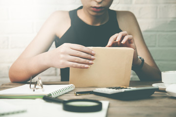Fototapeta premium Woman opening letter in the office table