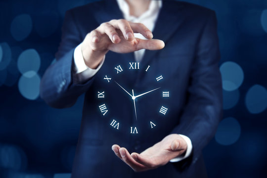 Businessman hand holding clock in screen
