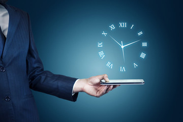 Businessman hand holding phone with clock in screen