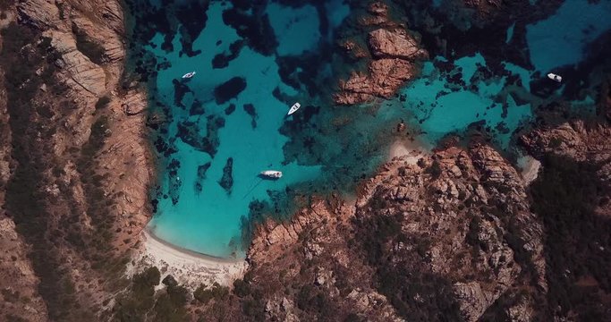 Aerial video of a paradisiac beach on the island of Mortorio in Sardinia, incredible island of the Emerald Coast in Italy.