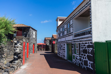 Fototapeta na wymiar PICO, AZORES - AUGUST 3, 2016: The village of Lajido between vineyards, with houses built with lava stone, Pico, Azores, Portugal