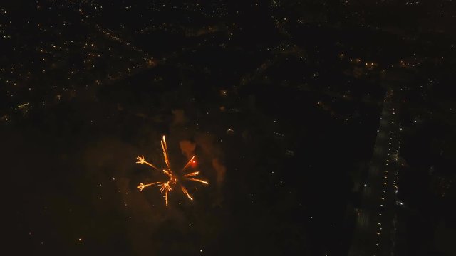 Aerial view Beautiful fireworks video from the drone in the night sky on celebration. Sparks. Fireworks are a class of explosive pyrotechnic devices used for aesthetic and entertainment purposes