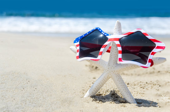 Patriotic USA background with starfish on the sandy beach