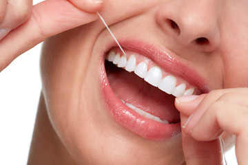 woman smile with tooth floss