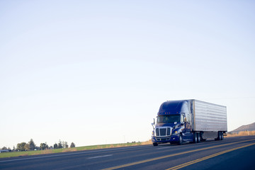 Blue modern semi truck reefer trailer carry cargo on highway © vit