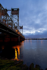 Evening Big Lifting Bridge over Columbia River with lights reflected in water