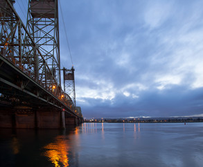 Naklejka na ściany i meble Long drawbridge over Columbia River with night lights reflection