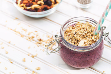 Smoothie topped with granola in a mason jar