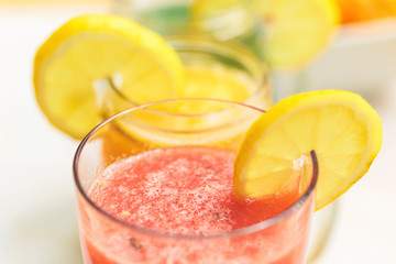 Three smoothies on a white wooden background