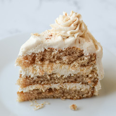 cinnamon roll layer cake with three layers and cinnamon swirl frosting