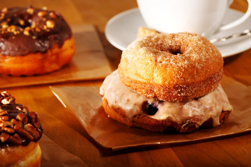 Donuts with coffee on a rustic wooden background
