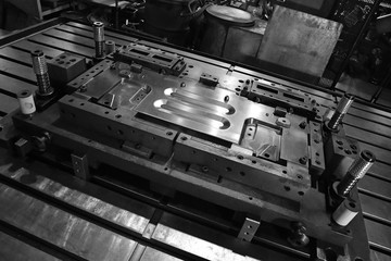 Sheet Metal Stamping Tool Die for Automotive Precision Parts on The Numerical Control Milling Machine Table. Tandem Stamping System. At a High Quality Technology Factory. Black and White Photography. - obrazy, fototapety, plakaty