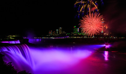 Niagara Falls night time illuminated with fireworks