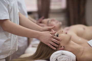 couple enjoying head massage at the spa