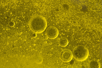 Bubbles of  water in olive-oil.
