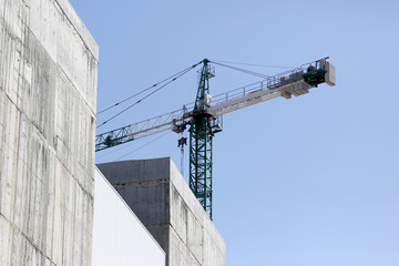 Fototapeta premium large construction crane at the construction of buildings.