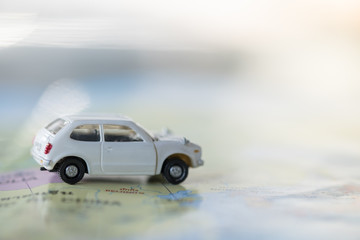 Fototapeta na wymiar Travel and Transportation concept. Mini white car toy on world map with copyspace.