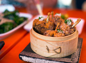 Fried chicken wings on  plate made ​​of birch bark