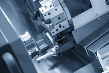 Abstract scene of CNC lath machine (Turning machine) while cutting the screw thread on the tube.The hi-technology machining concept.