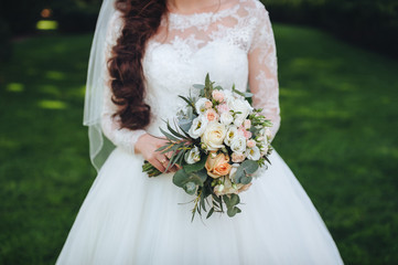 Wedding bouquet in bride's hands.