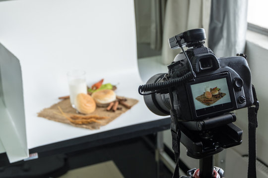 DSLR camera to shooting bread and glass of milk in  indoor photo studio
