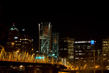 Night view of the illuminated drawbridge on city background