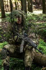 Camouflaged soldiers in forest