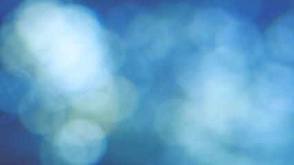 Abstract blue background with beautiful flickering particles. Underwater bubbles in flow with bokeh