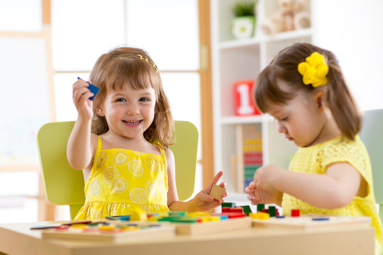 kids playing with developmental toys at home or kindergarten or playschool
