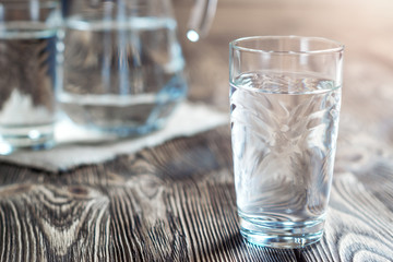 Glass of water on a wooden table.