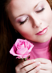 Pretty woman with pink rose