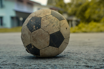 Fototapeta na wymiar Old soccer ball on fall