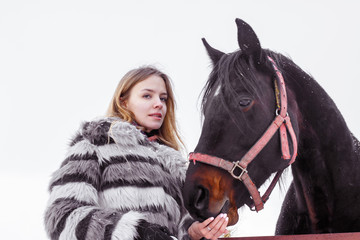 Obraz premium Nice girl and horse outdoor in a winter