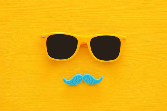 Father's day concept. Hipster yellow sunglasses and funny moustache