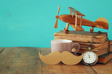 Fototapeta na wymiar Cup of coffee with vintage father's accessories. Father's day concept