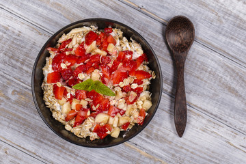 Muesli made from red strawberries, banana, chia seeds, oat flakes, honey and dressed with yogurt
