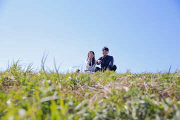 Naklejka na ściany i meble japanese young couple outdoor green