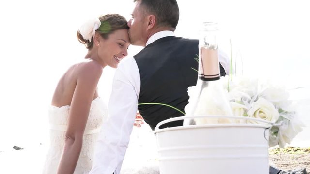Happy bride and groom celebrating wedding with champagne