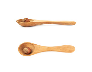 Hazelnut in a wooden spoon isolated