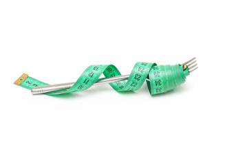 Diet concept.  Fork and measuring tapes isolated on white