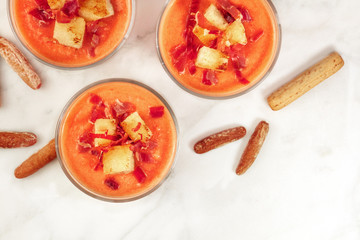 Salmorejo served in glasses with breadsticks, place for text